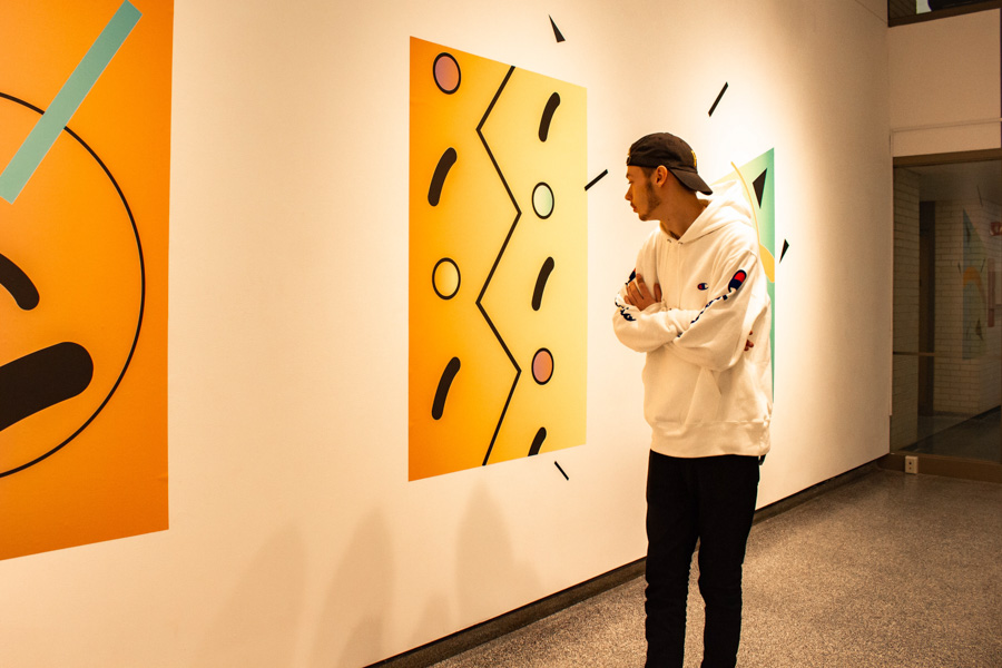 A male WSU student explores an art exhibit.