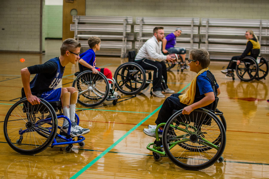 A WSU student teacher provides a physical education lesson to kids using wheelchairs.