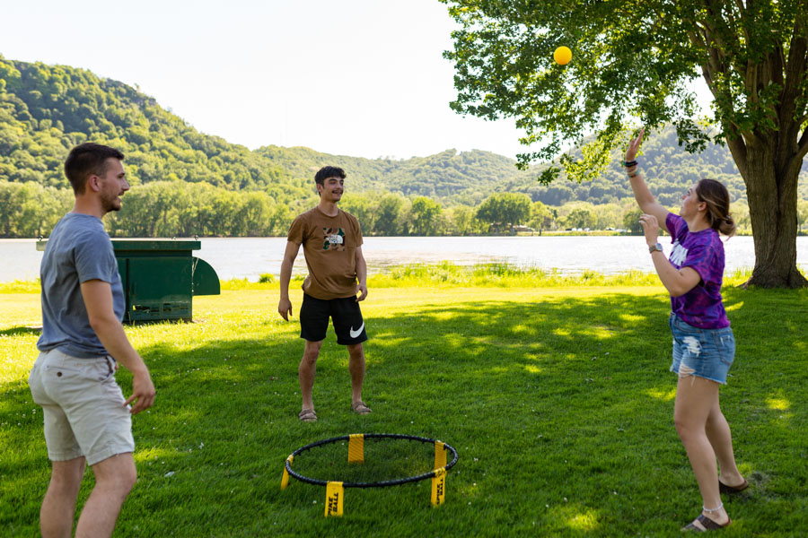 WSU students play spikeball by Lake Winona.